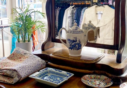 Charity shop viewed through a dresser mirror display