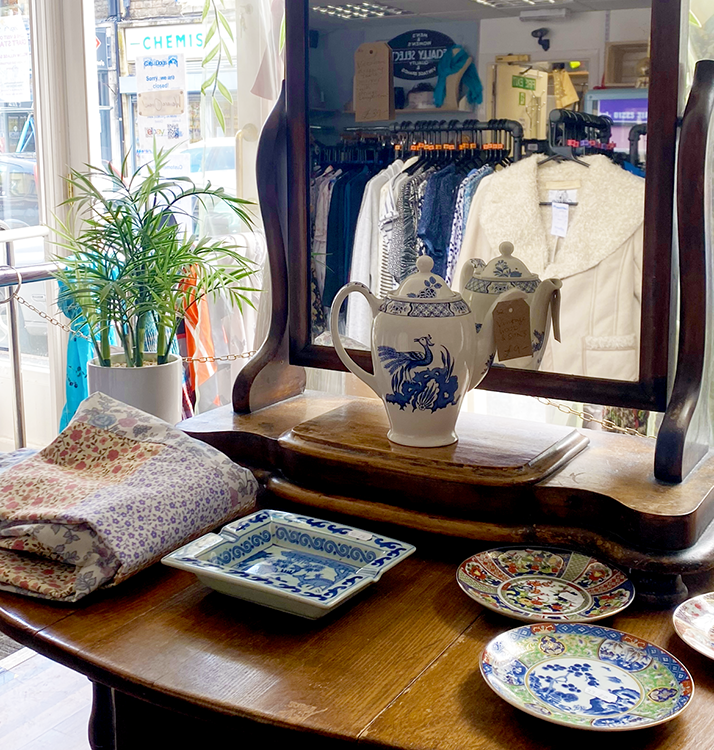 Charity shop viewed through a dresser mirror display 